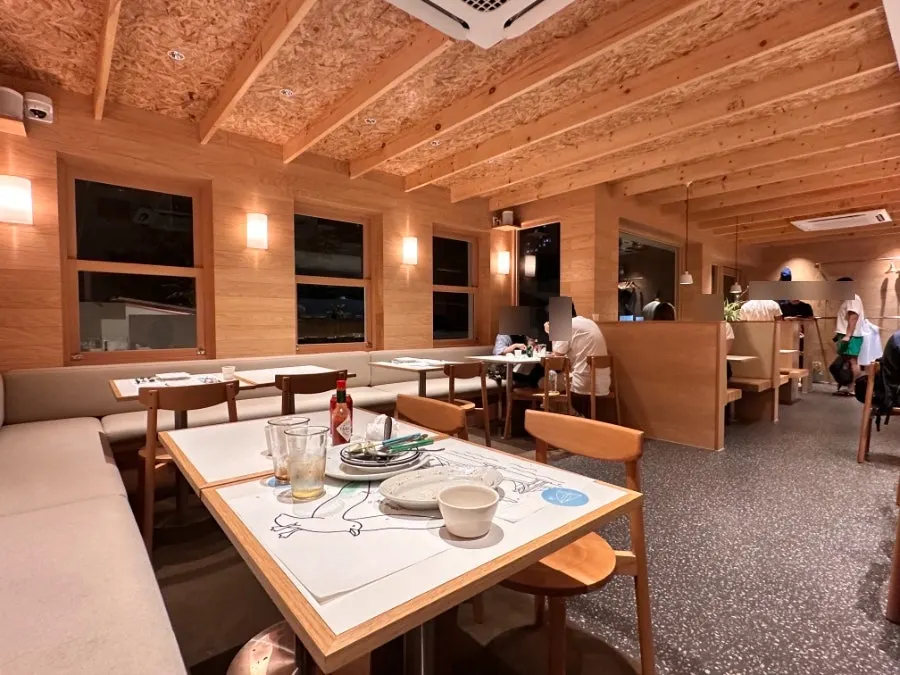 Extra Mile interior with large windows and tidy tables