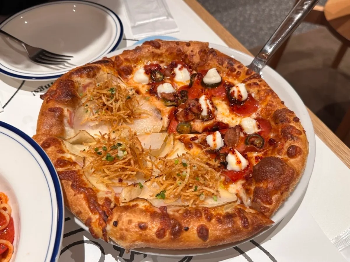 Potato pizza topped with sliced potato and potato shreds
