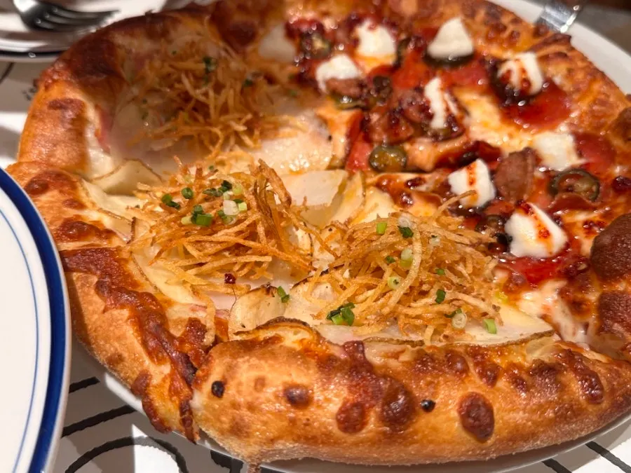 Hot honey pepperoni pizza topped with hot honey sauce and pickled peppers