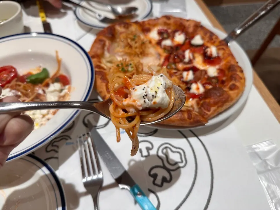 Tomato pasta topped with stracciatella cheese