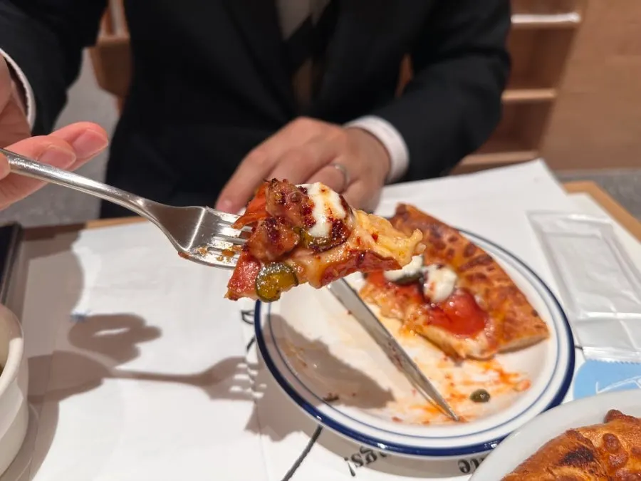 Scooping a portion of tomato pasta