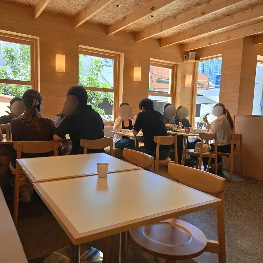 Warm-atmosphere table seating area at Extra Mile