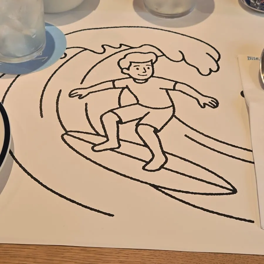 Crayons in a paper cup on the table