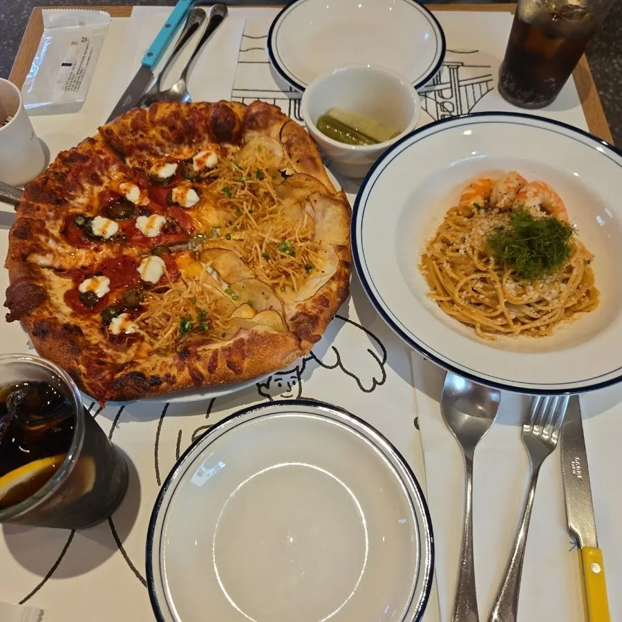 Half-and-half pizza and bisque cream pasta spread on the table