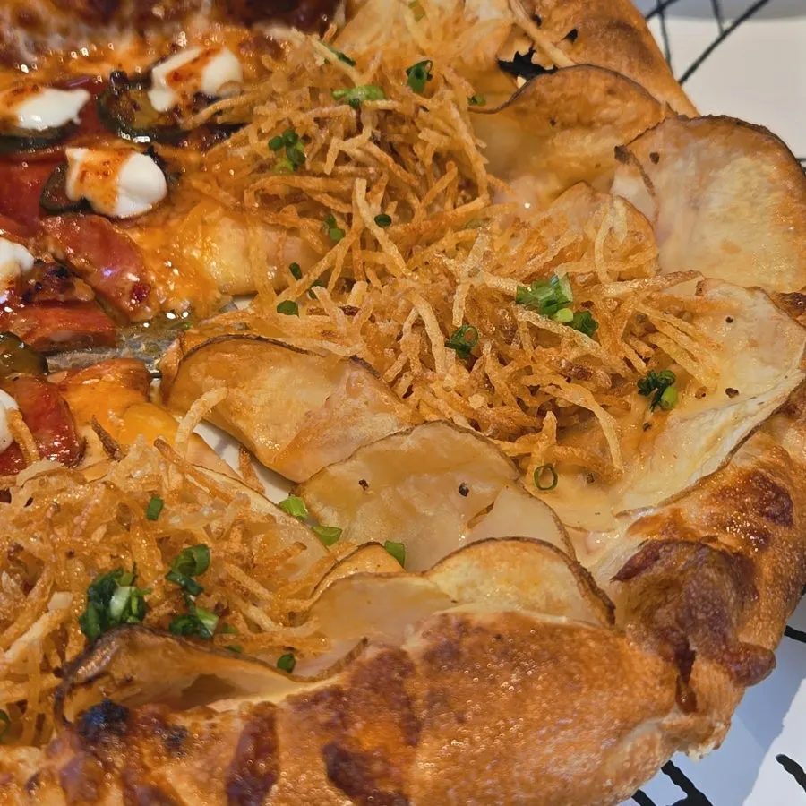 Potato pizza topped with dubaek potatoes and truffle oil