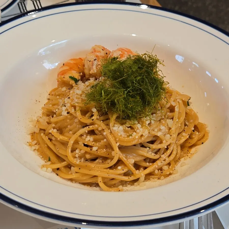 Plate of bisque cream pasta topped with shrimp