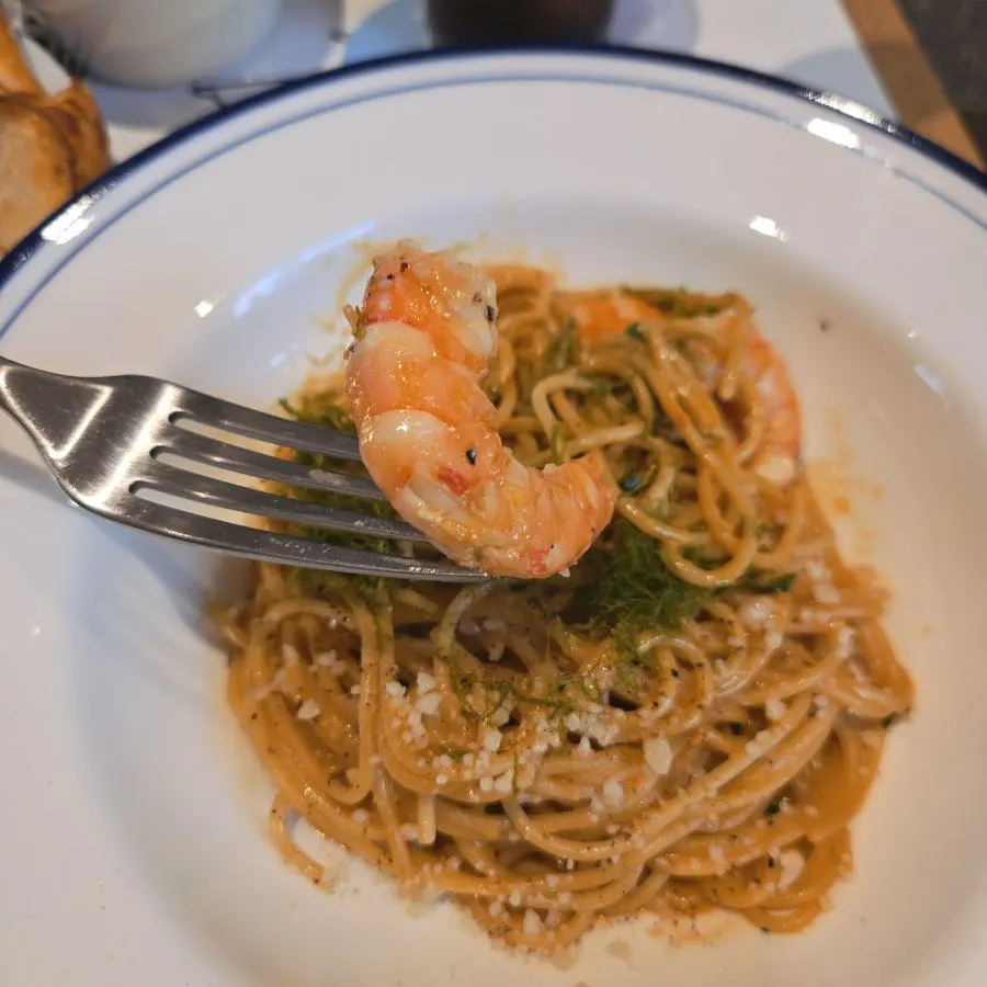 Fork twirling bisque cream pasta with shrimp