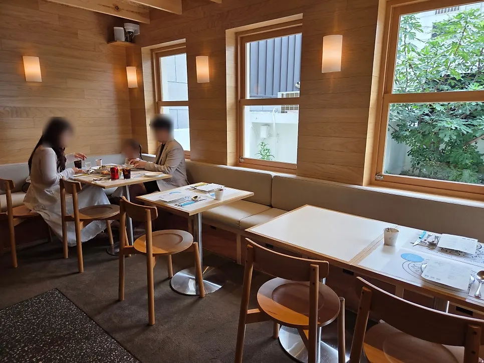 Extra Mile's white building exterior with wood-tone windows