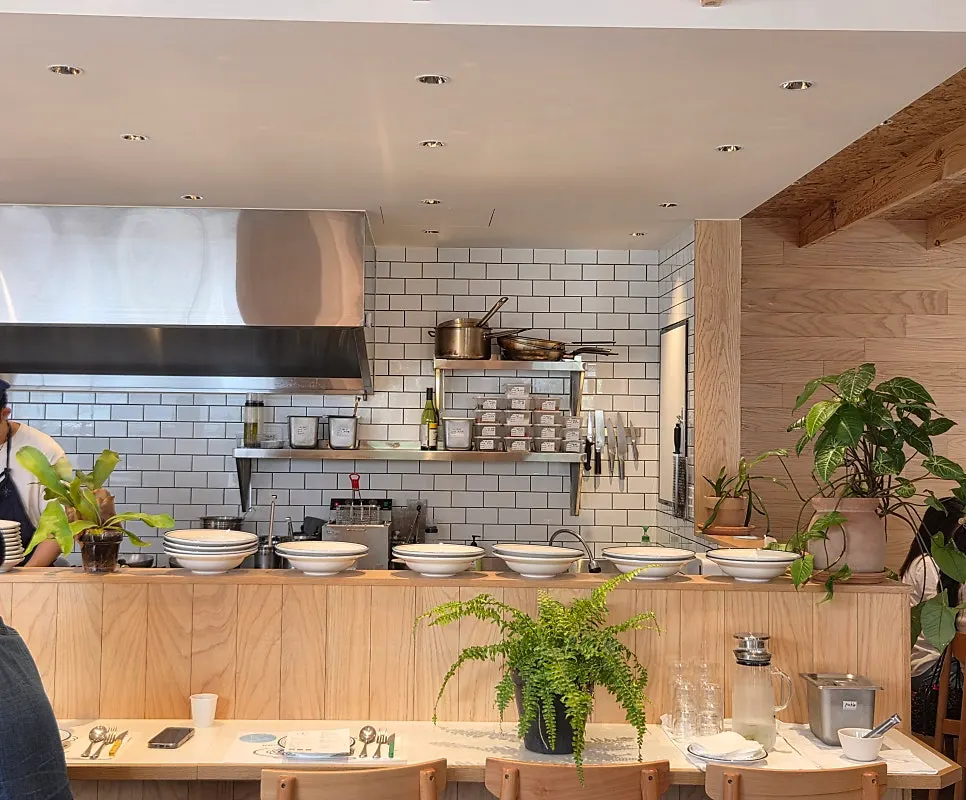 Interior decorated with wood-tone furniture and plants
