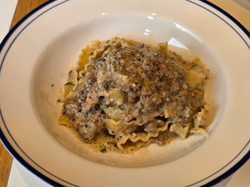 A plate of white ragu pasta