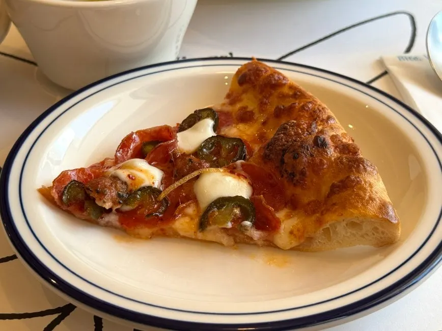 Slices of potato pizza and hot honey pepperoni pizza