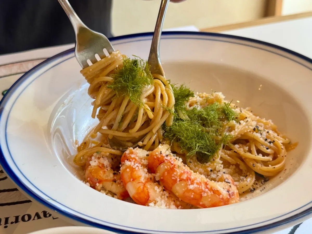 A bite of bisque cream pasta with gamtae pressed on