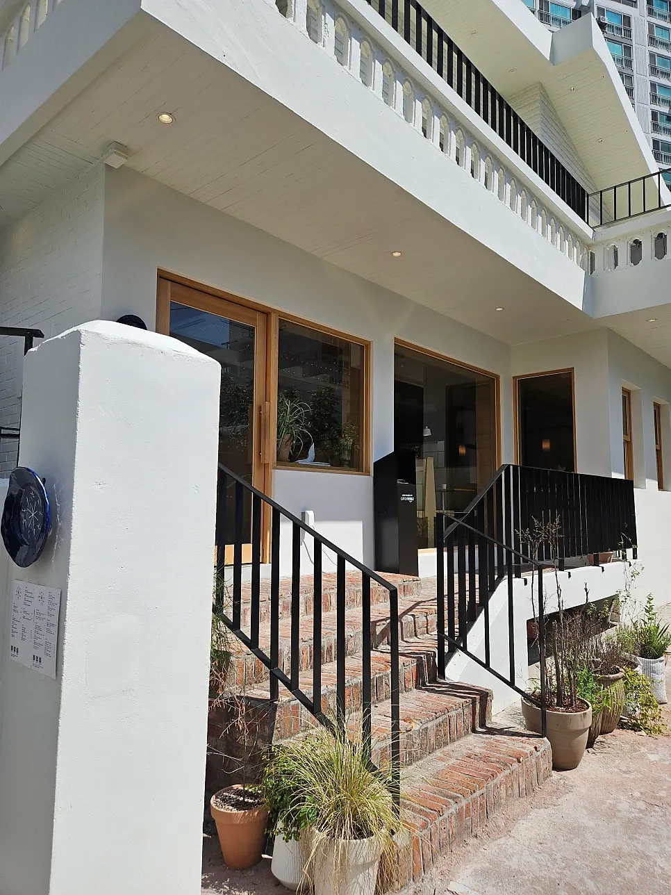 White-toned exterior of Extra Mile, a Gwangalli Western-style restaurant