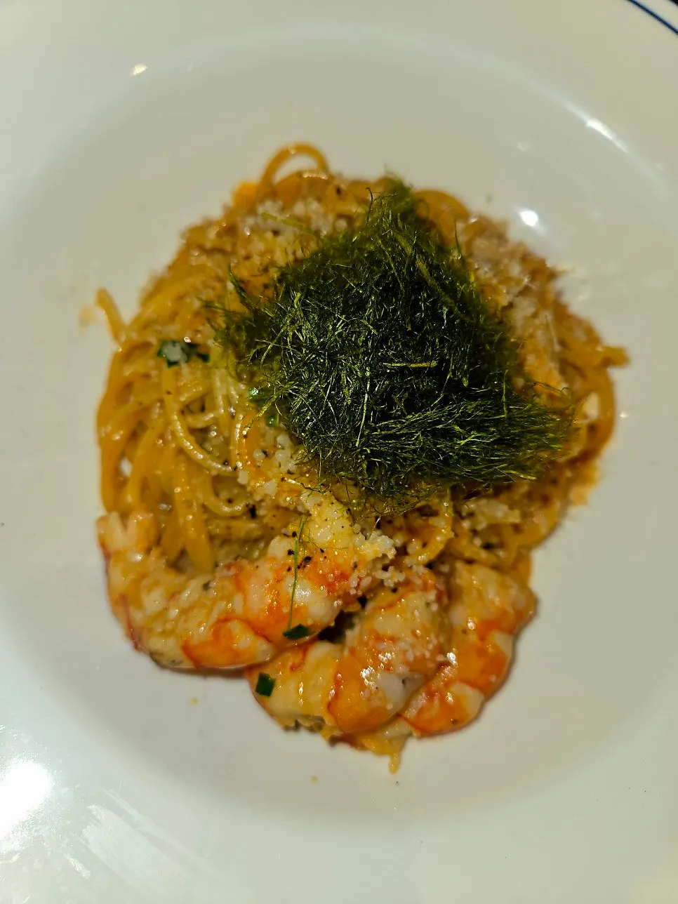 Bisque cream pasta topped with large shrimp