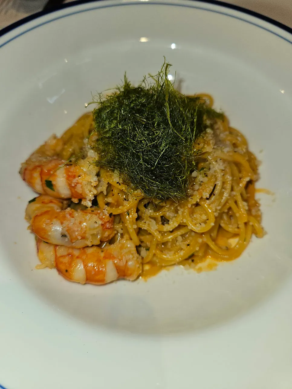Close-up of bisque cream pasta topped with seaweed