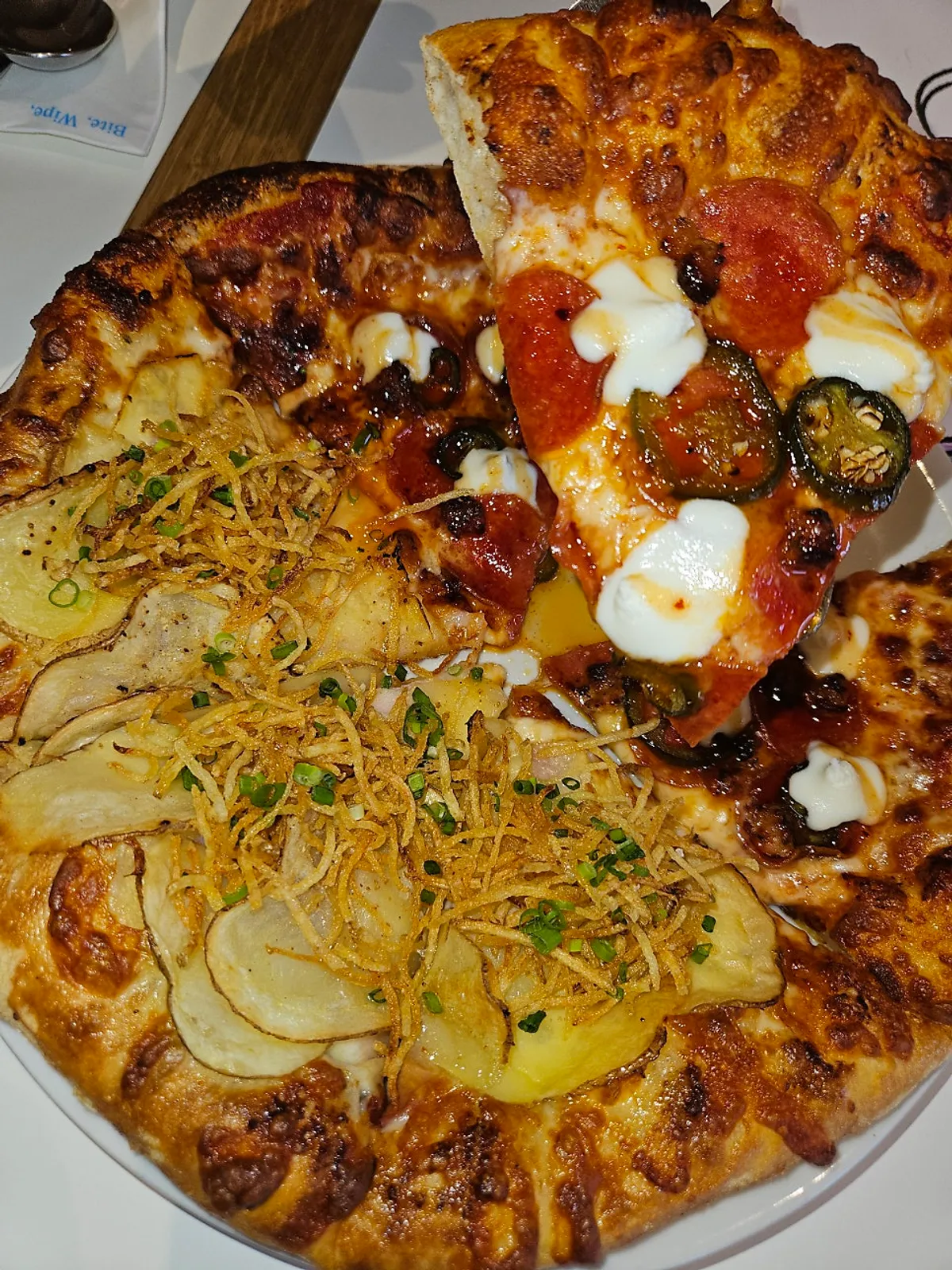 Slice of potato pizza topped with potato shreds