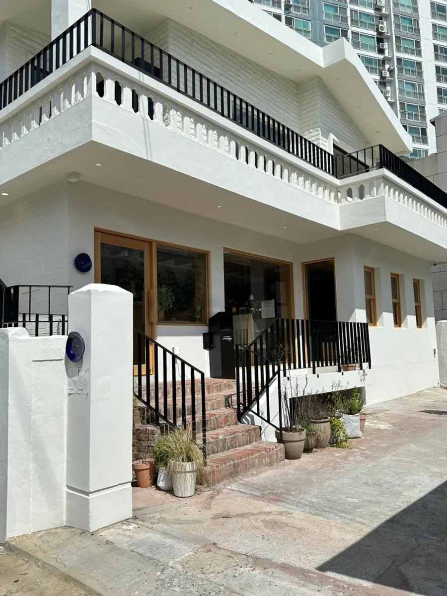 White-painted building exterior down an alley