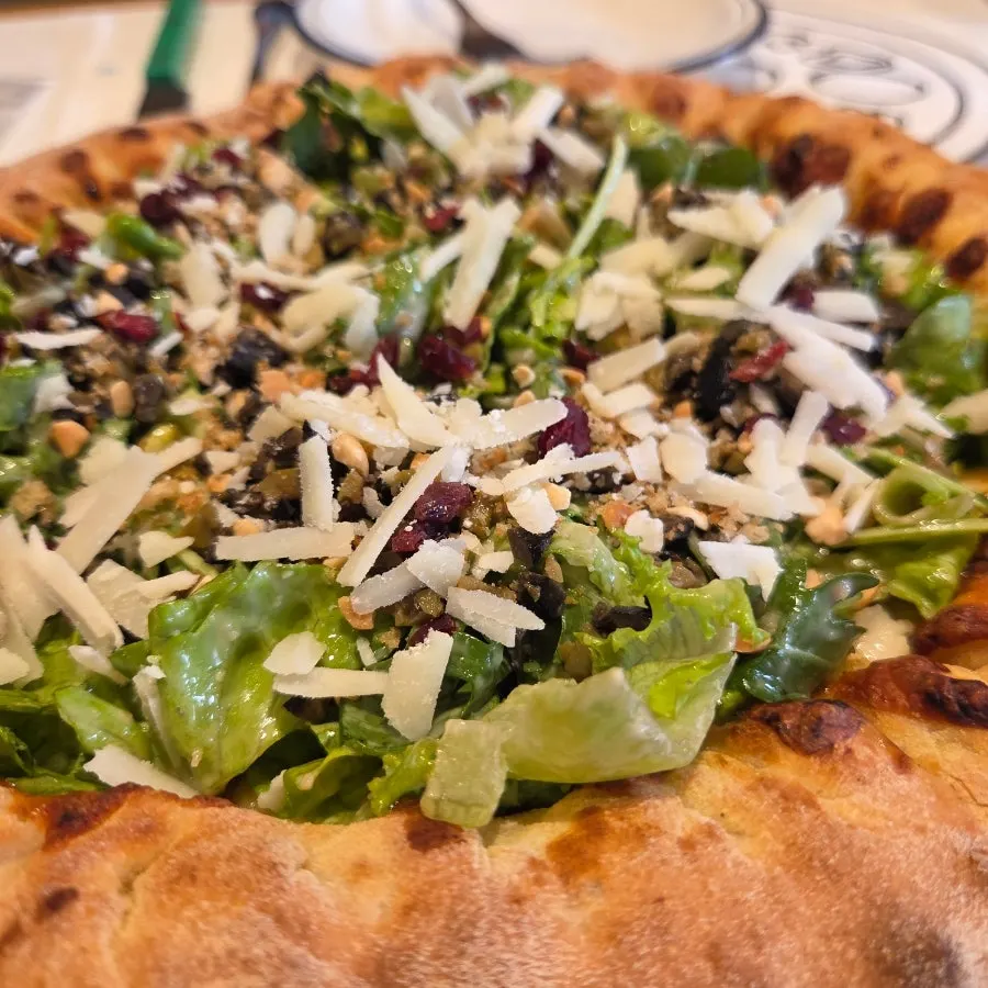 Extra Mile's salad pizza with cheese crust added