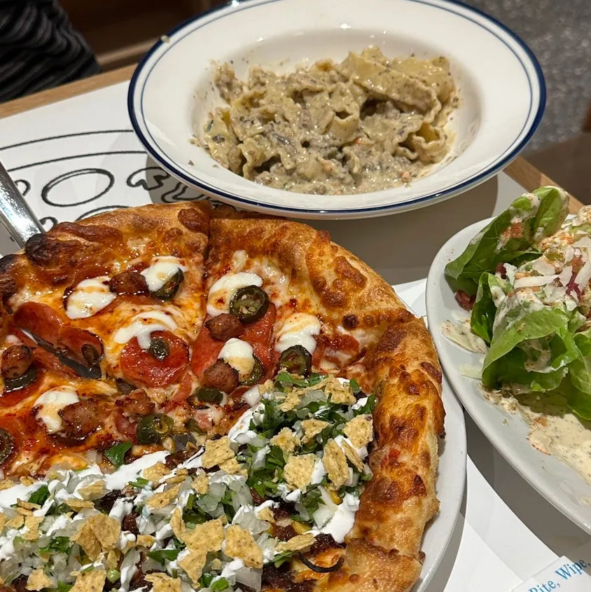 Table of pizza and pasta at Extra Mile in Gwangalli