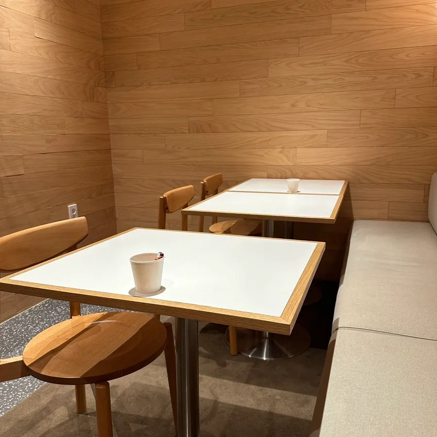 Bar seats and a four-person table at Extra Mile