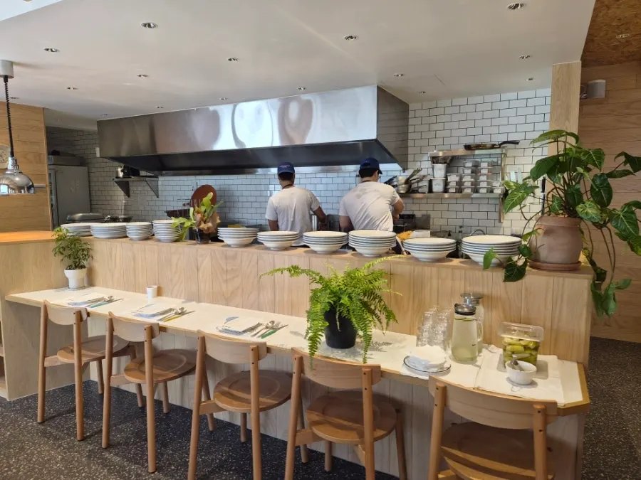 Open kitchen at Extra Mile preparing pizza