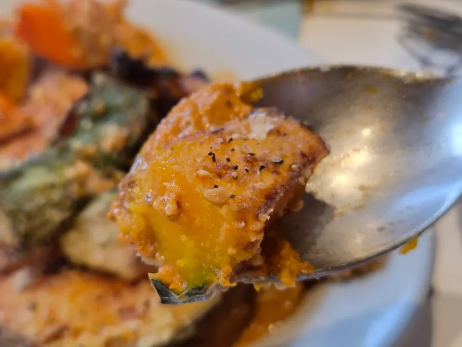 Pizza crust end dipped in romesco sauce