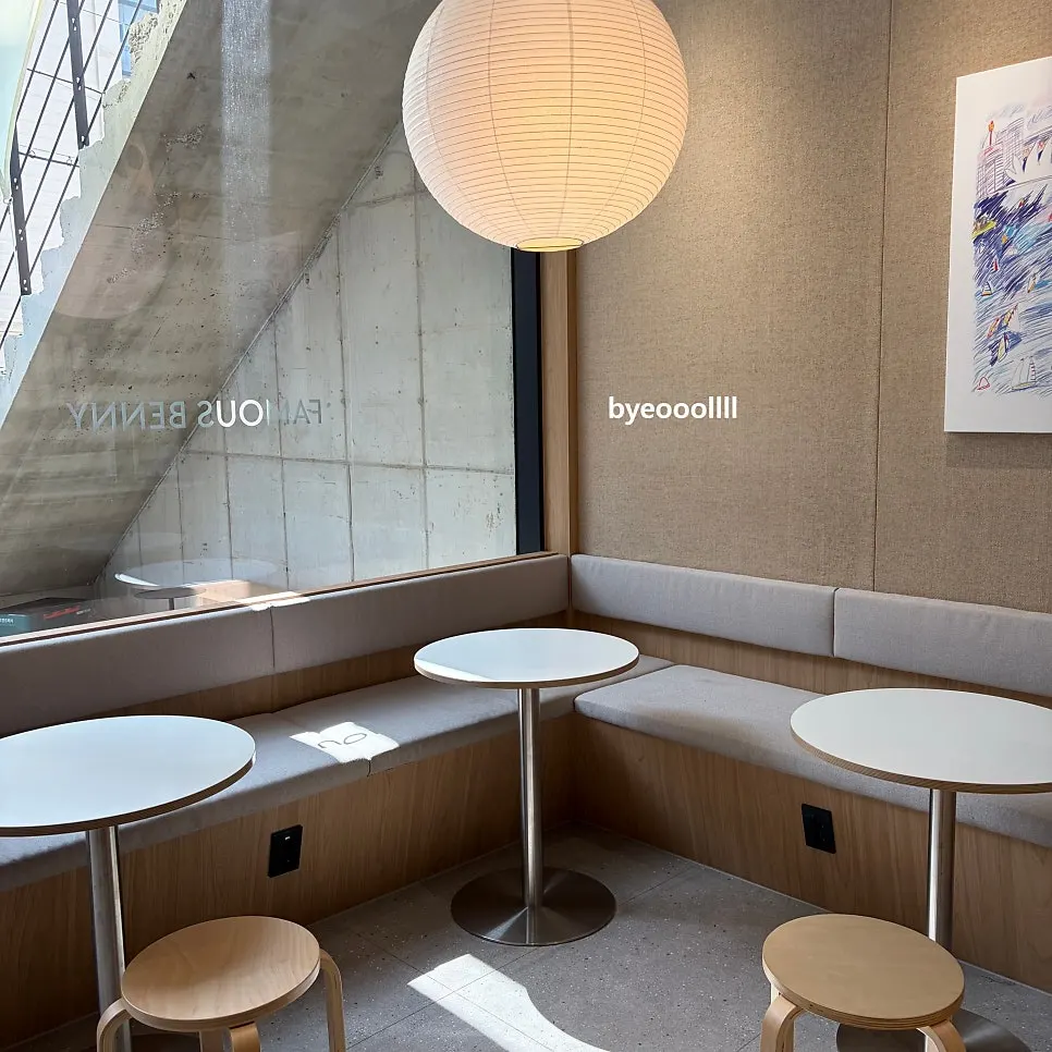 Wood-toned café interior with sunlight through large windows