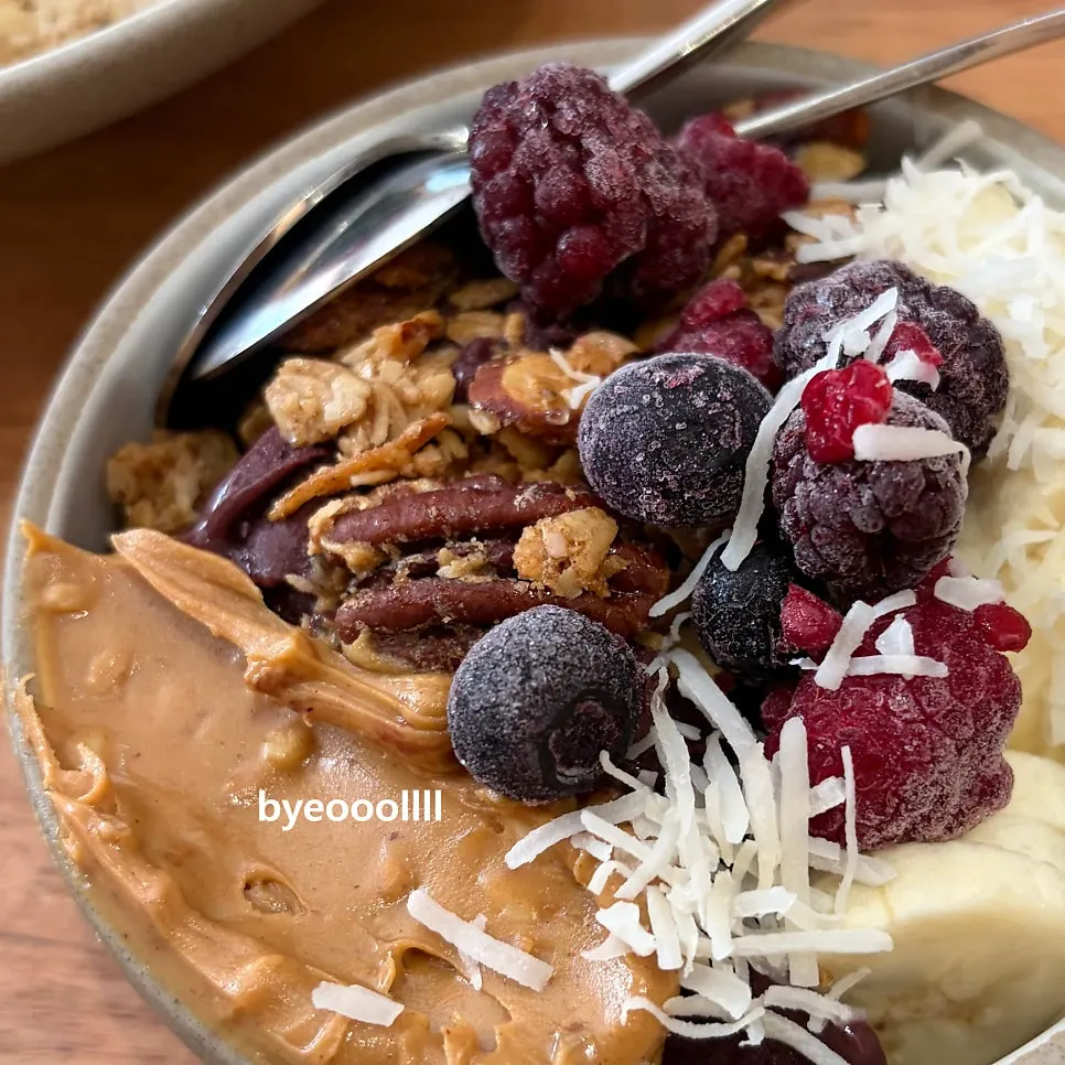 Acai bowl topped with banana, berries, and granola