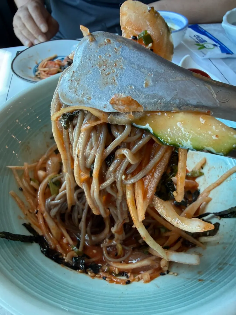 A table full of banchan spread at Geumrang Hoetjip
