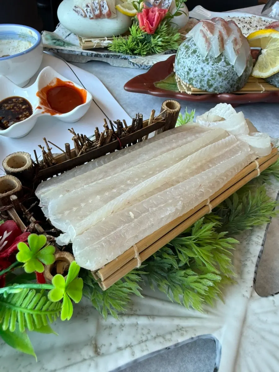 A finished plate of sashimi-topped sushi