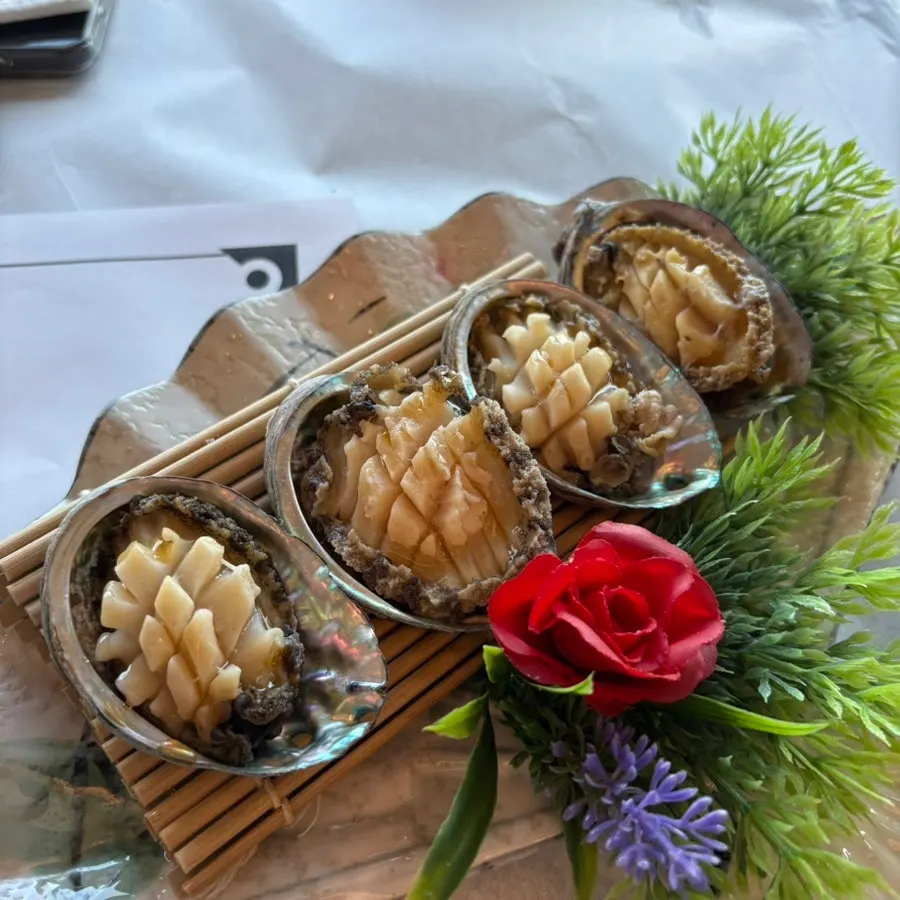 Plate of scored steamed abalone and nakji tangtangi