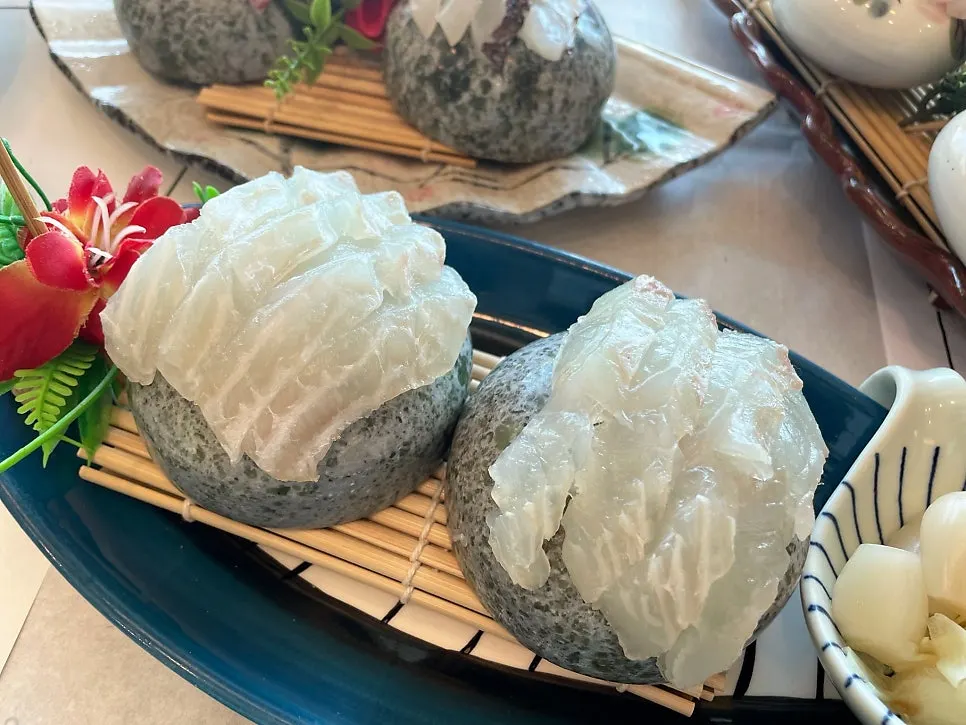 Cross-section of assorted sashimi cut differently to bring out each texture