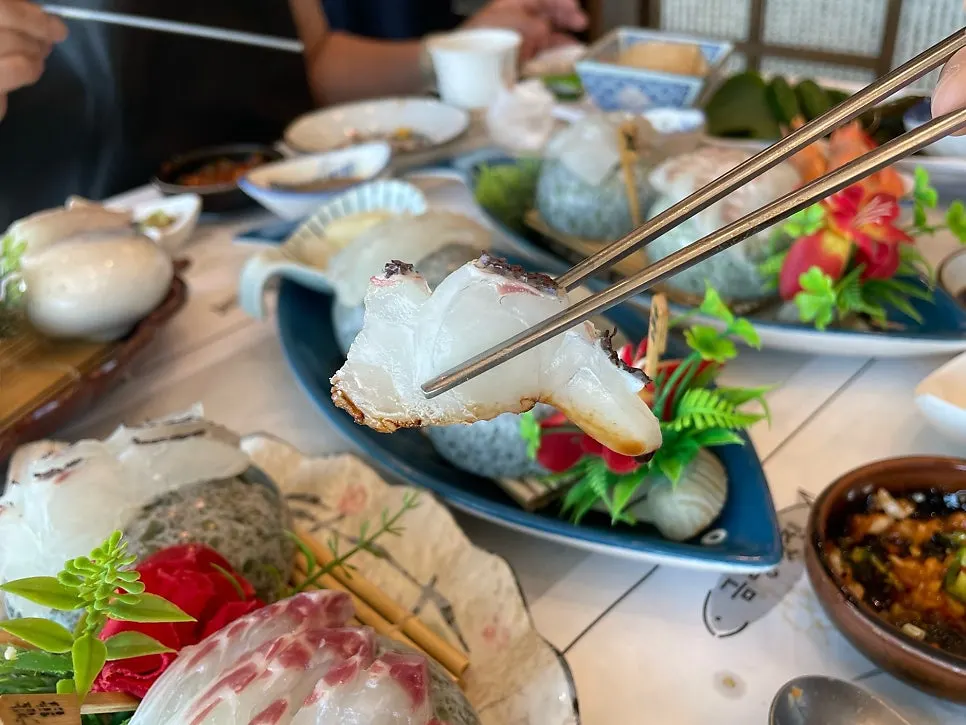 Sashimi spread set against the Gwangan Bridge view