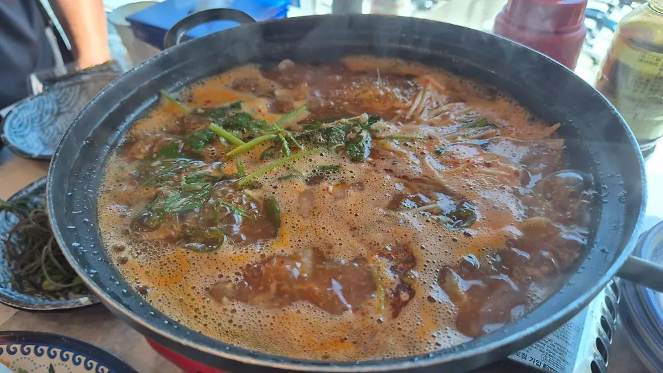 Crispy corn fritters and rich, spicy fish stew