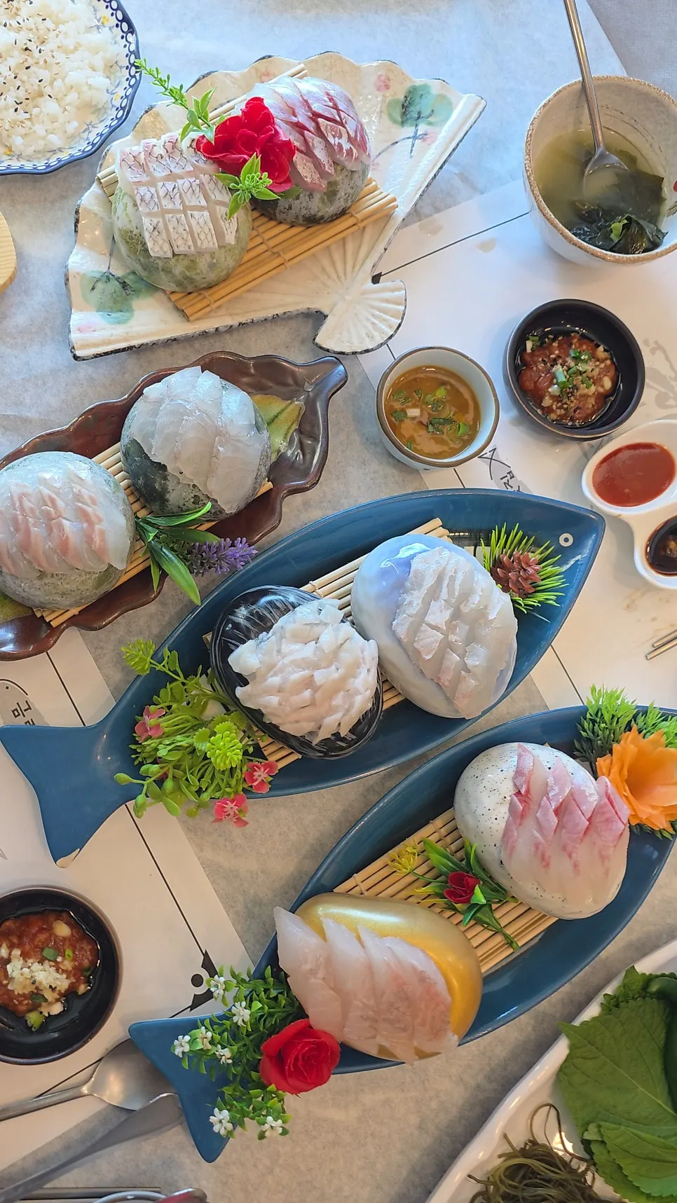 Mixed sashimi served across four plates