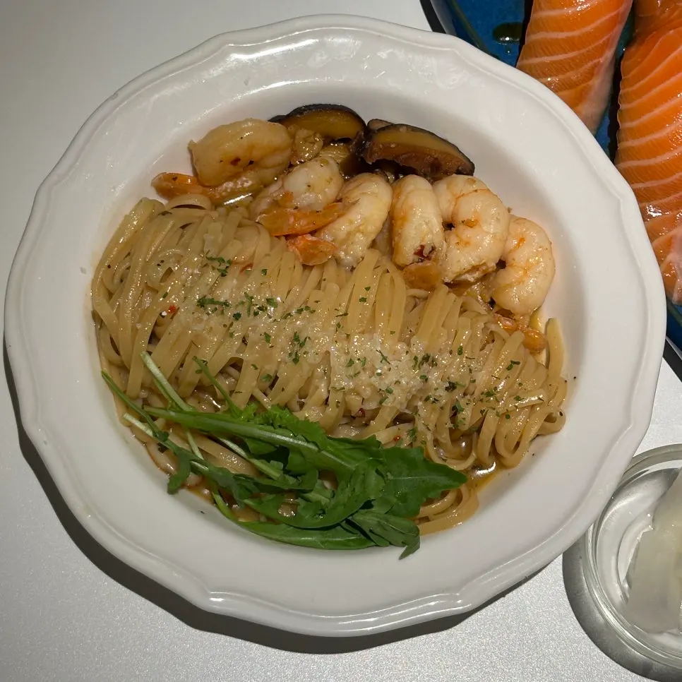Salmon sushi and pasta meal spread