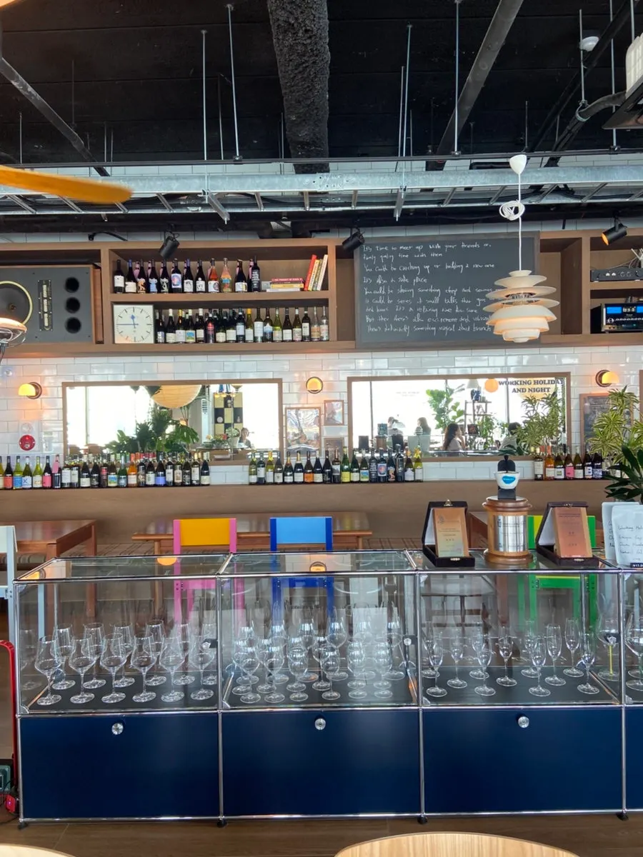 Café interior display area decorated with wine bottles