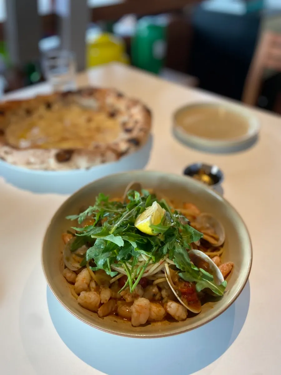 A plate of shrimp oil pasta topped with shrimp