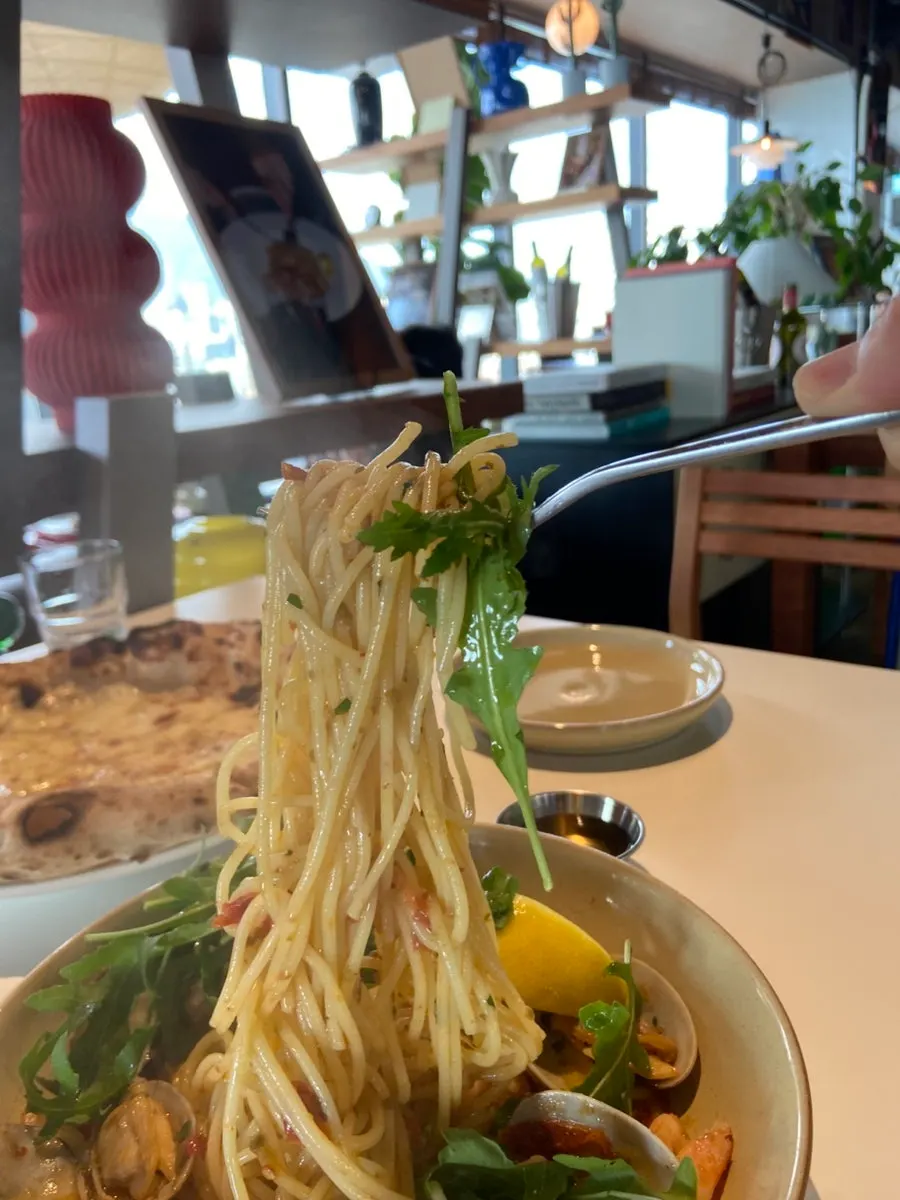Plump shrimp and garlic visible in the oil pasta