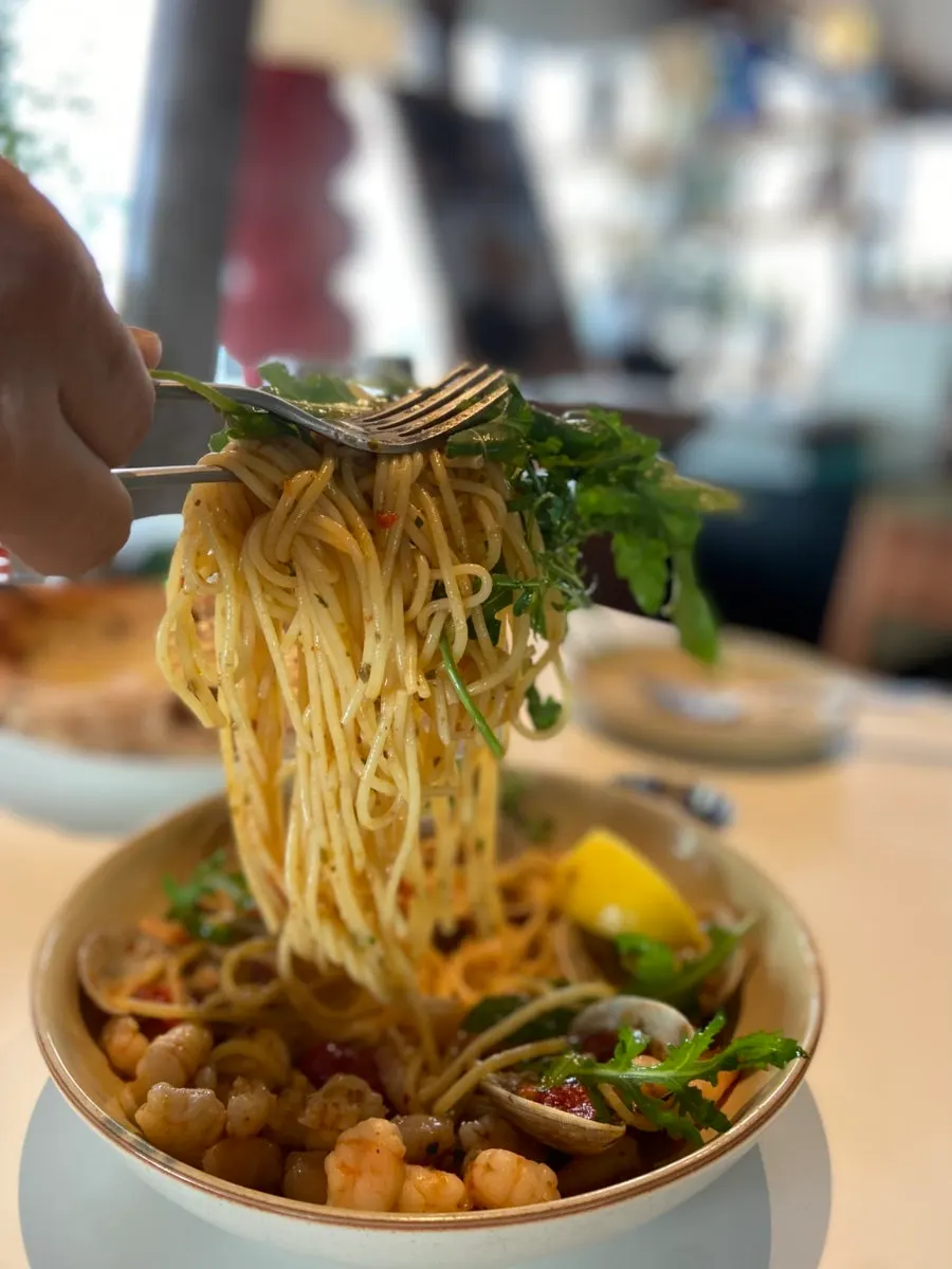 Thin oil pasta noodles twirled around a fork