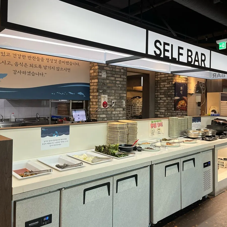 Self-serve side dish corner with banchan laid out