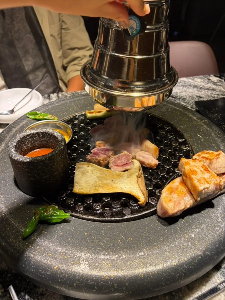 Nearly empty meat plate over the charcoal grill