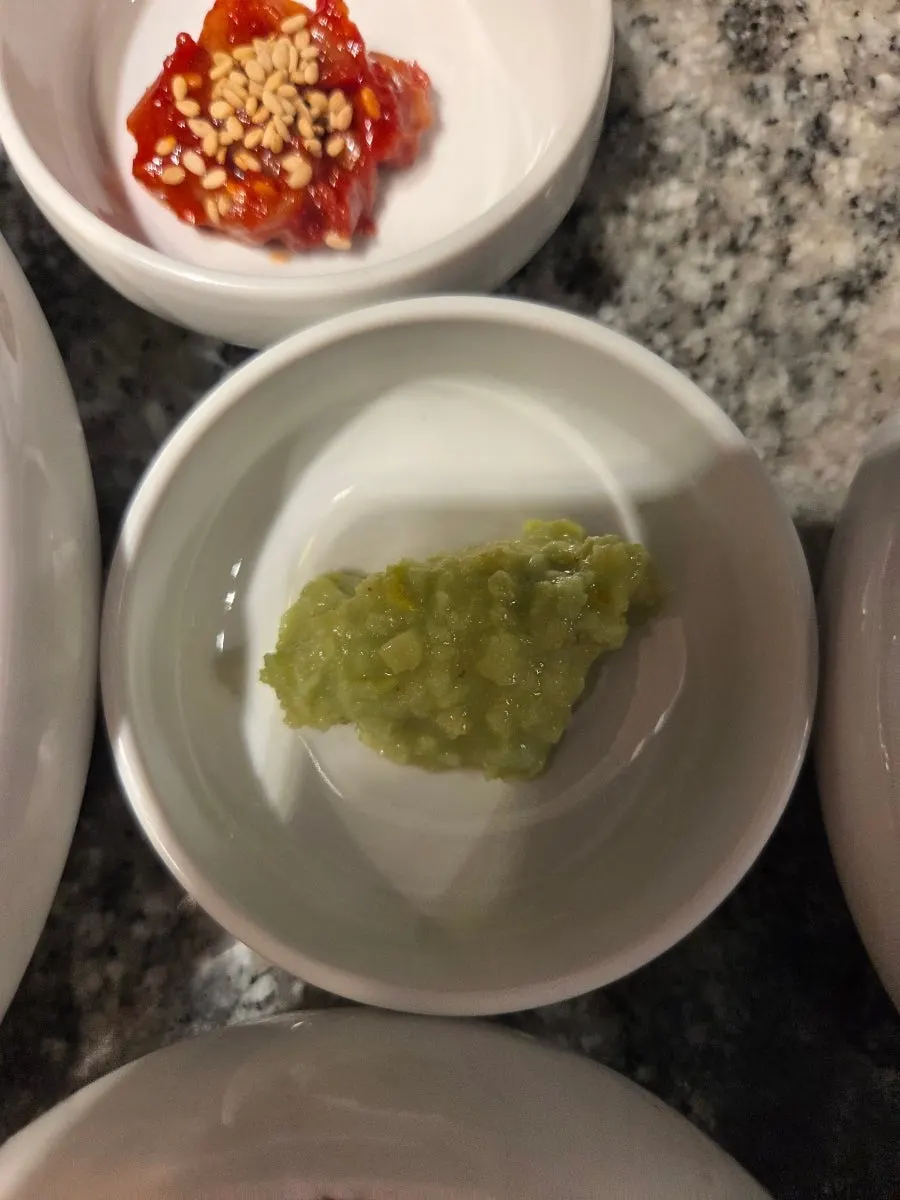 Green onion kimchi served alongside the meat
