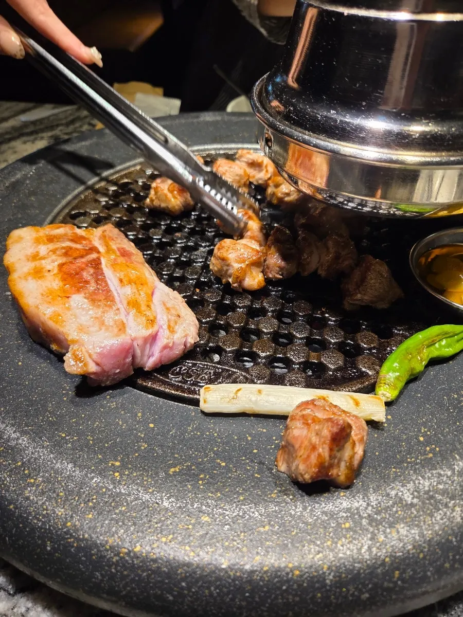 A tray of charcoal-grilled meat cut into bite-sized pieces