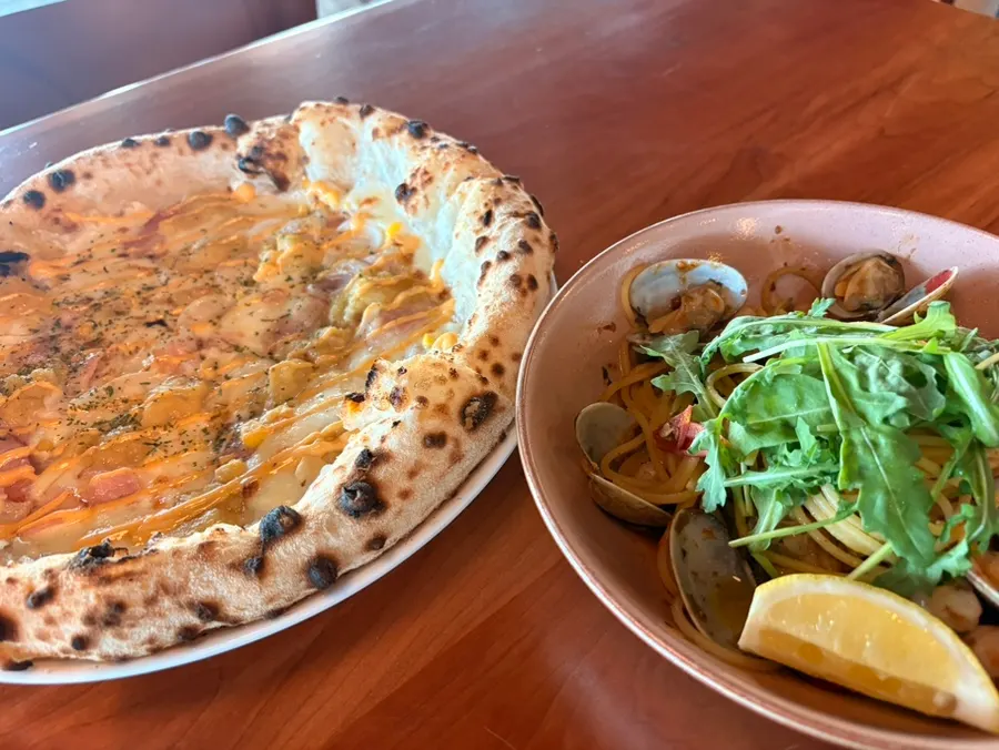Honey sweet potato pizza and shrimp oil pasta set on the table