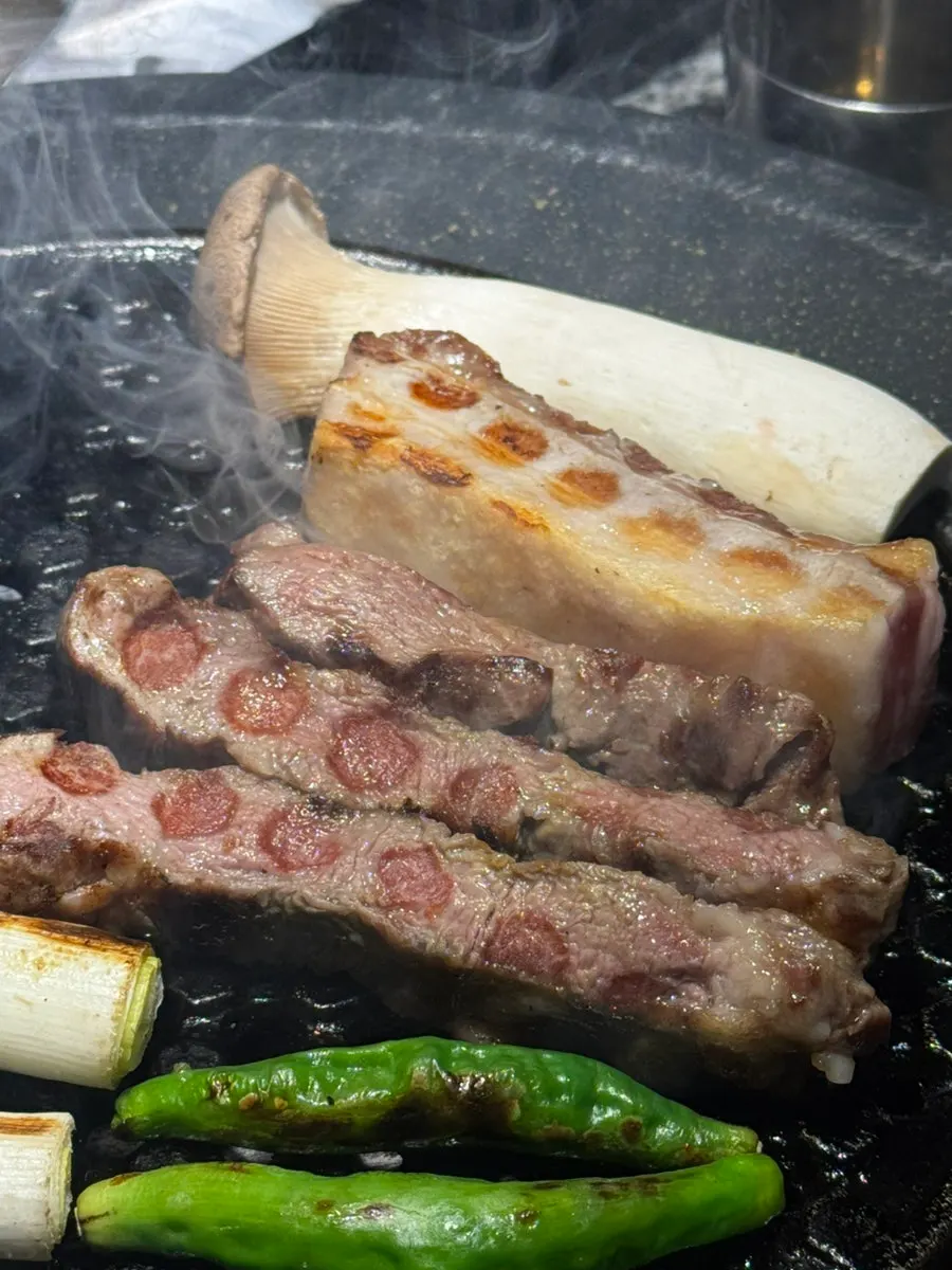 Iberico and vegetables cooking on the grill