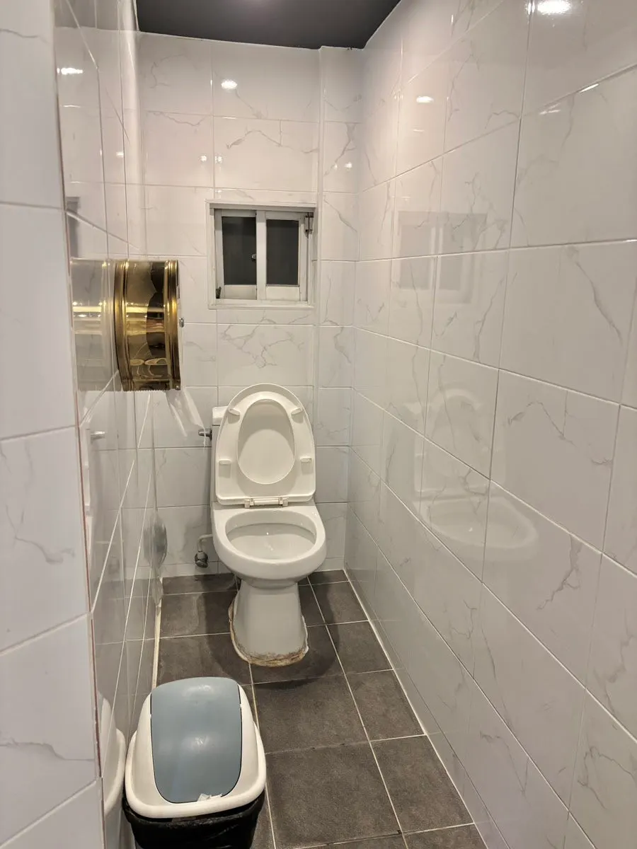 Bathroom stall stocked with toilet paper