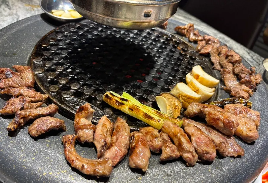 Iberico pluma, cheek meat, and intercostal cut grilling over charcoal