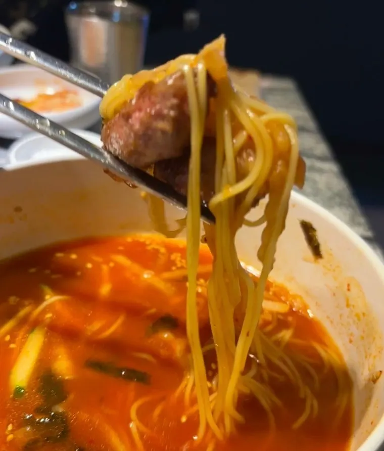 Close-up of kimchi noodle soup noodles and kimchi