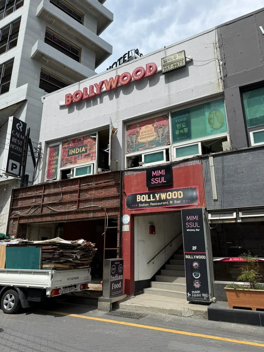 Sign for Bollywood Indian Restaurant on the 2nd floor of a building on the Gwangalli café street